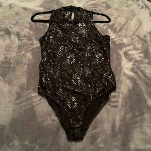 Material girl bodysuit w/ partial open back. Color is black and a bit of silver